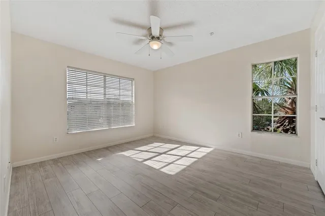 a view of an empty room with a ceiling fan