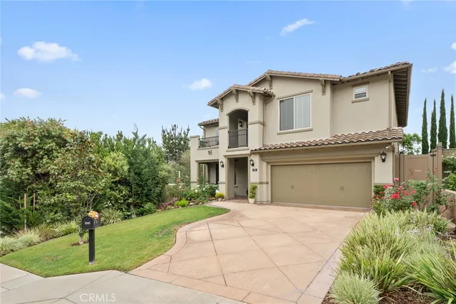a view of a white house with a yard and plants