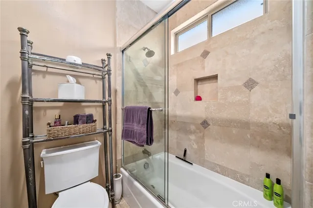 a spacious bathroom with a granite countertop sink mirror and a shower