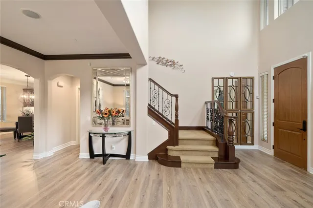 a view of a hallway with wooden floor and staircase