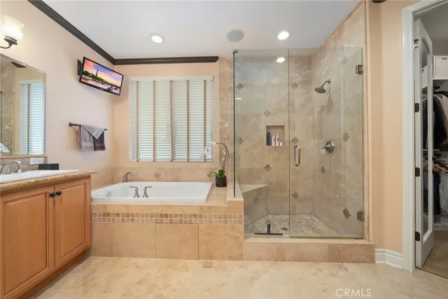 a large bathroom with a large mirror vanity and shower