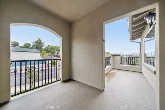 a spacious bedroom with a bed and a chandelier