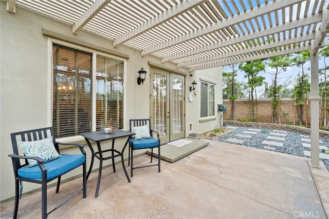 a view of a patio with table and chairs with wooden floor and fence