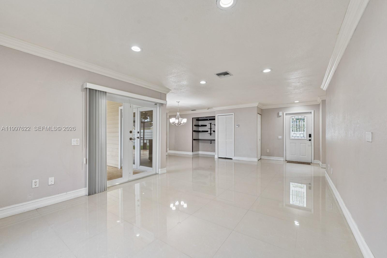 14912 Southwest 143rd Court, Unit 14912 Miami, FL 33186 - Photo 11 of 35 a view of a livingroom with wooden cabinets