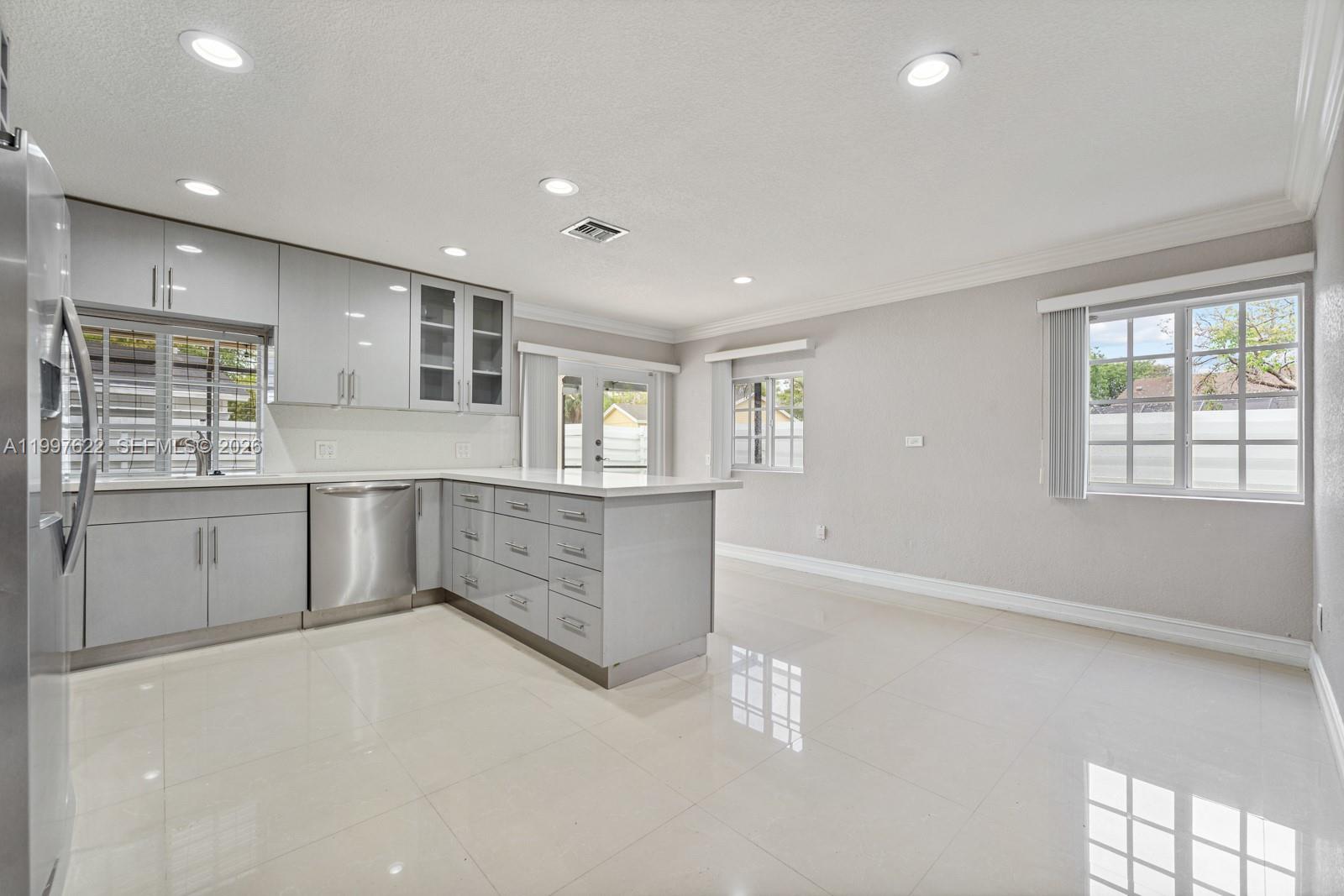 14912 Southwest 143rd Court, Unit 14912 Miami, FL 33186 - Photo 12 of 35 a large white kitchen with cabinets