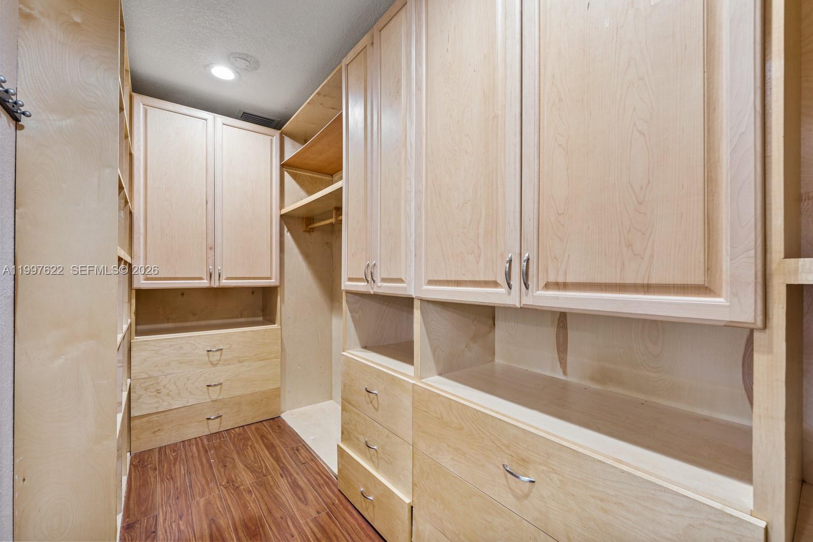 14912 Southwest 143rd Court, Unit 14912 Miami, FL 33186 - Photo 24 of 35 a view of walk in closet with empty racks