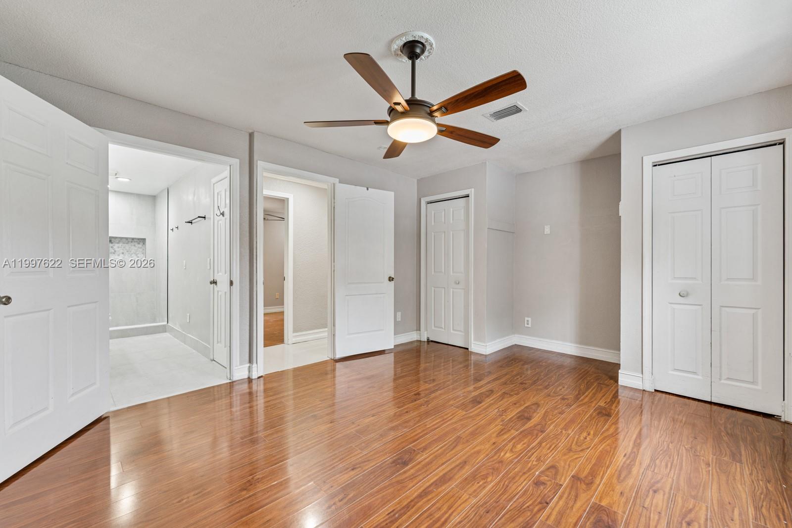 14912 Southwest 143rd Court, Unit 14912 Miami, FL 33186 - Photo 28 of 35 a view of an empty room and wooden floor