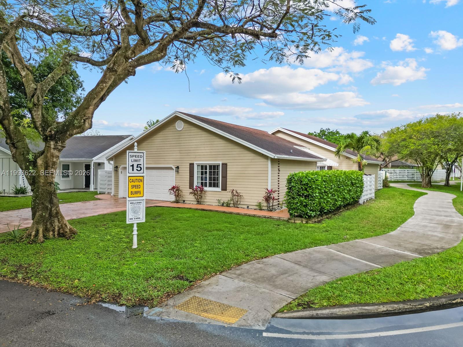14912 Southwest 143rd Court, Unit 14912 Miami, FL 33186 - Photo 3 of 35 a front view of a house with a yard