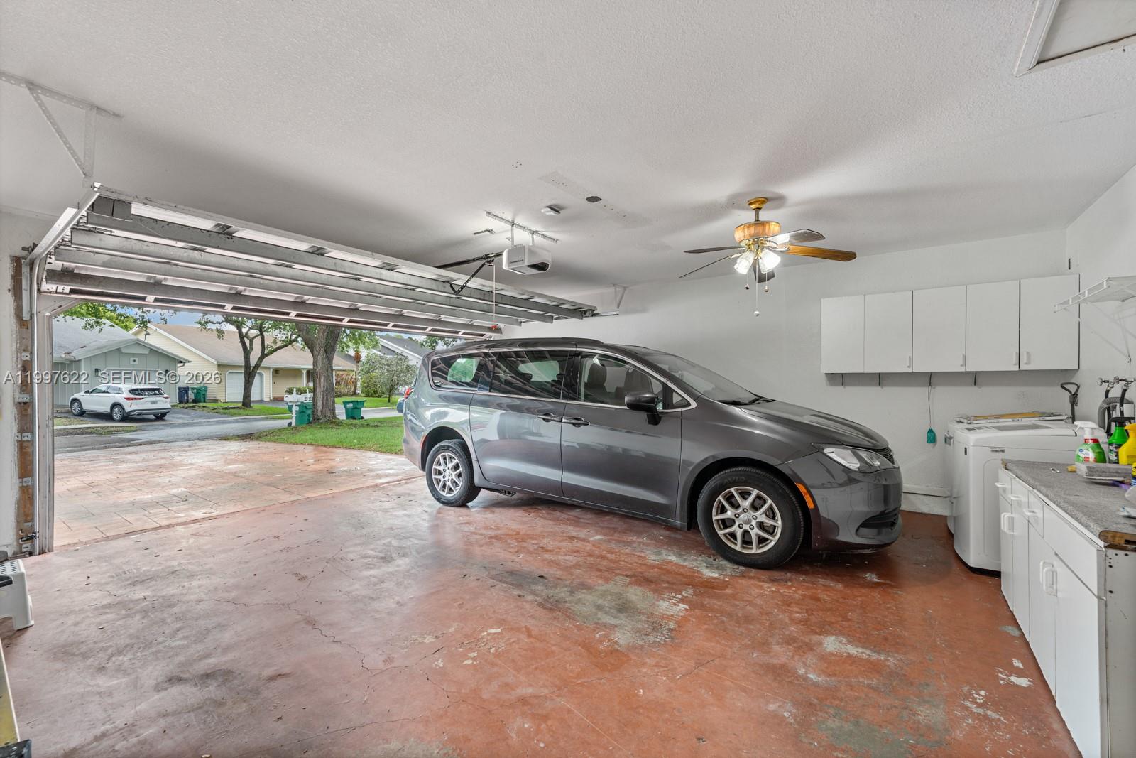 14912 Southwest 143rd Court, Unit 14912 Miami, FL 33186 - Photo 35 of 35 a view of a garage with car parked
