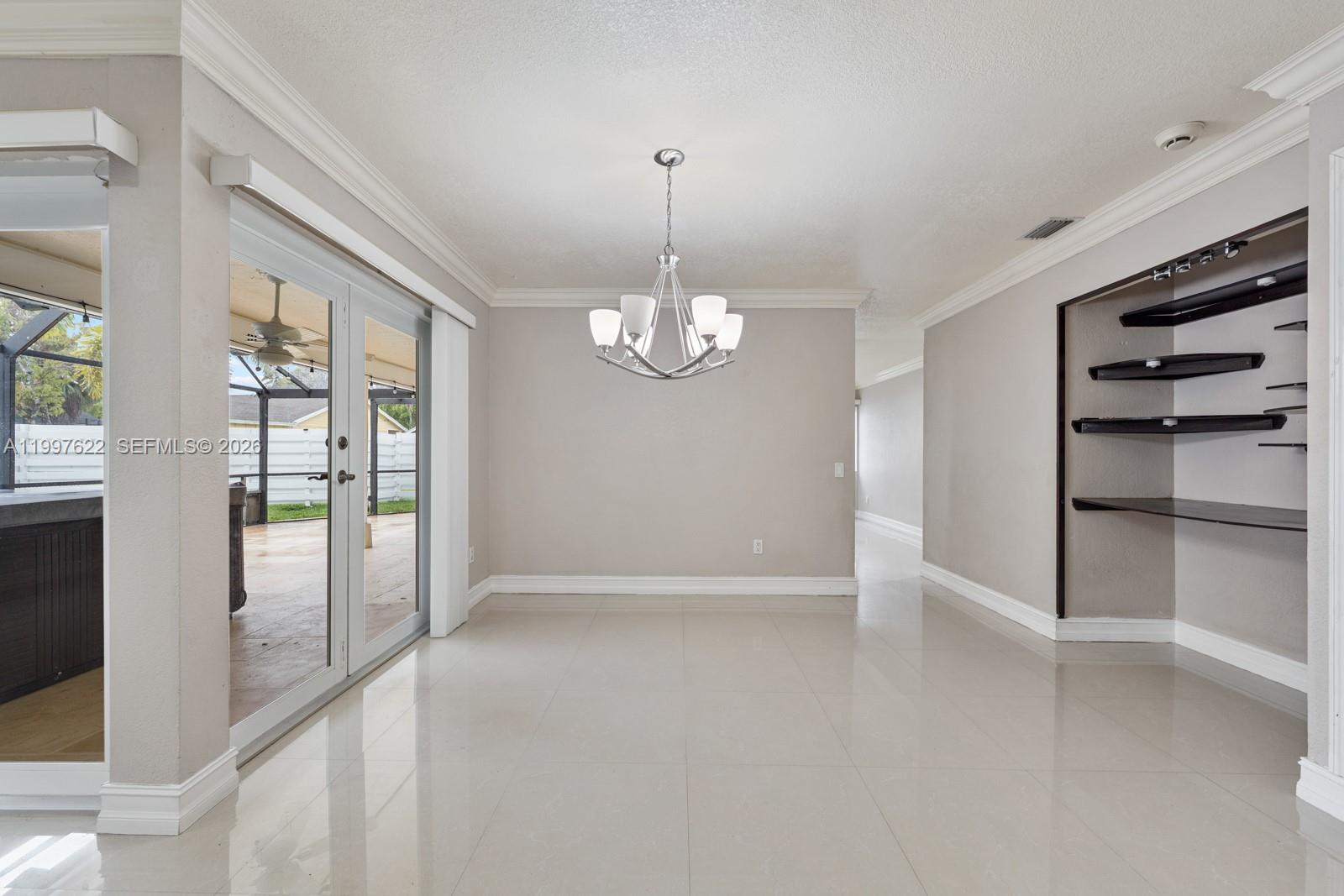 14912 Southwest 143rd Court, Unit 14912 Miami, FL 33186 - Photo 10 of 35 a view of an empty room with a window