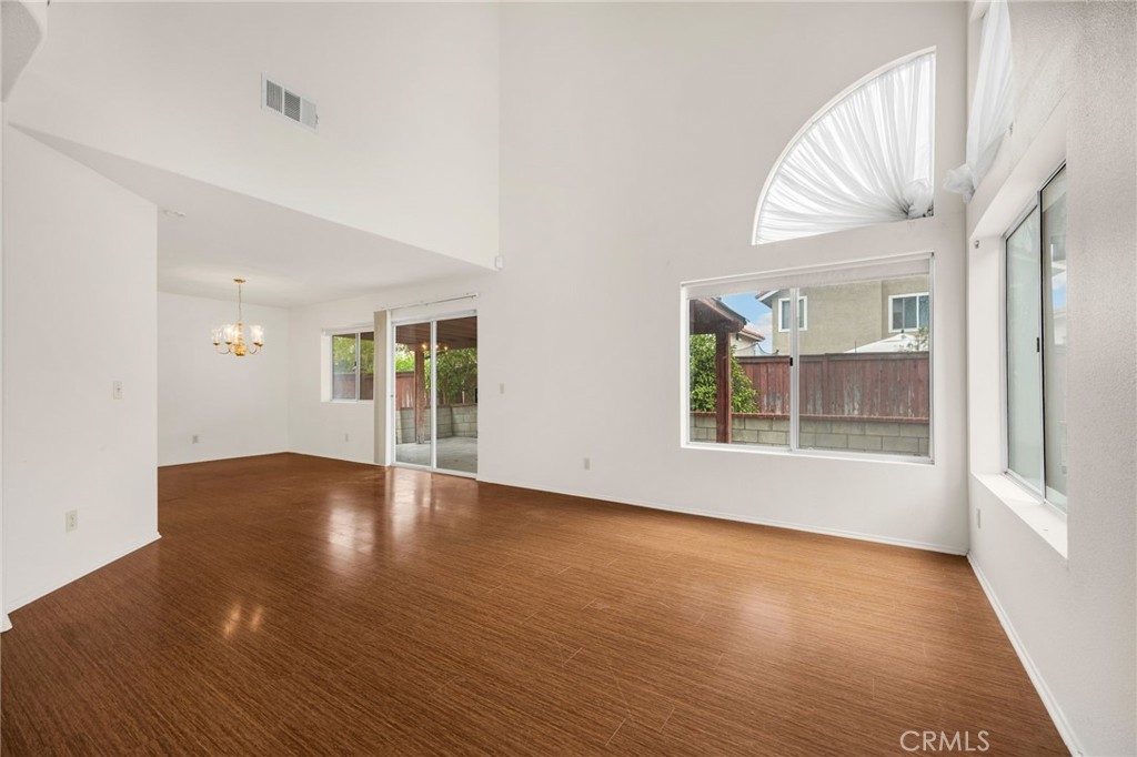 3631 Snowdrift Drive Riverside, CA 92503 - Photo 15 of 36 an empty room with wooden floor and windows