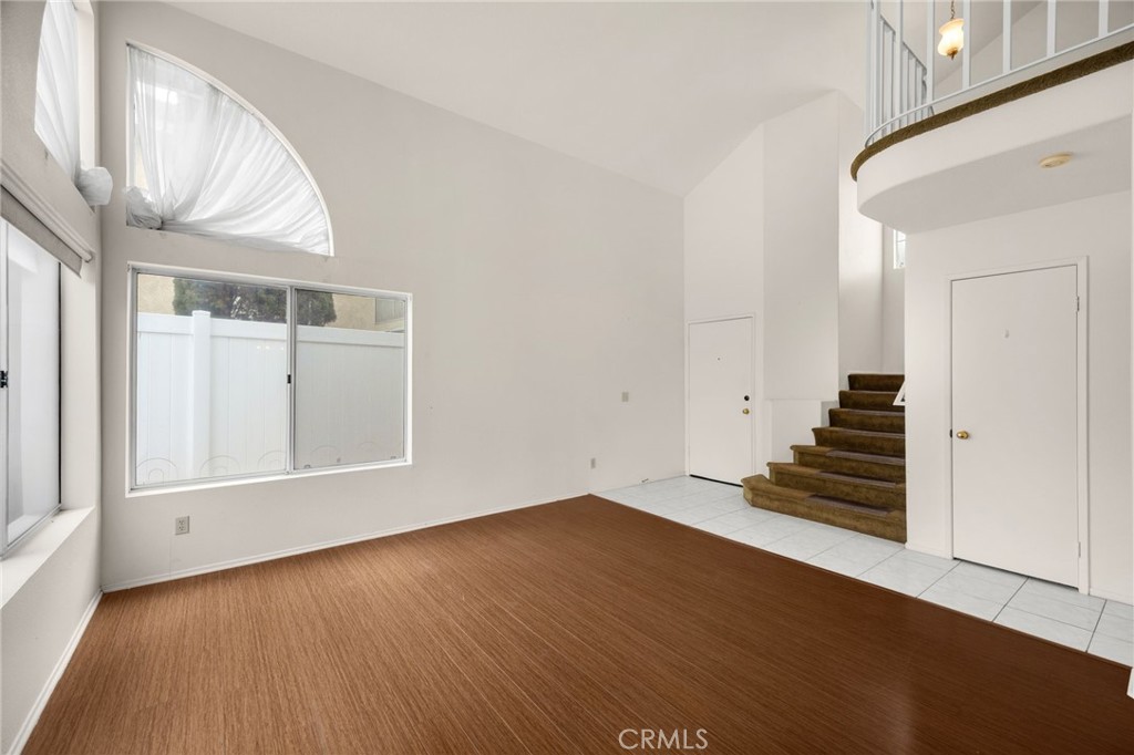 3631 Snowdrift Drive Riverside, CA 92503 - Photo 18 of 36 an empty room with wooden floor and windows