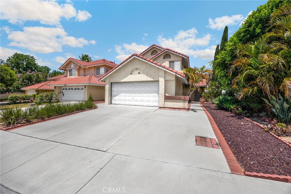 3631 Snowdrift Drive Riverside, CA 92503 - Photo 2 of 36 a front view of a house with a yard and garage