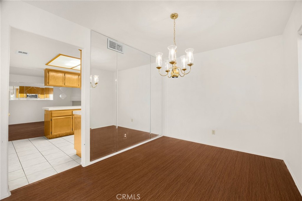 3631 Snowdrift Drive Riverside, CA 92503 - Photo 21 of 36 a view of a kitchen with kitchen island a sink wooden floor and a counter top space