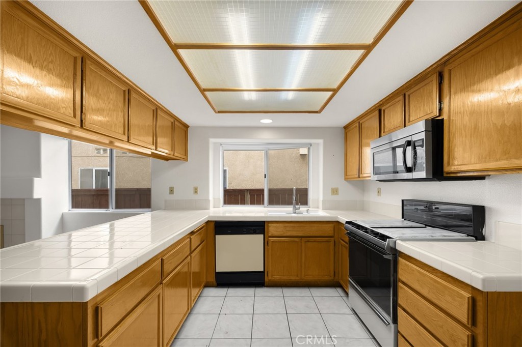 3631 Snowdrift Drive Riverside, CA 92503 - Photo 30 of 36 a kitchen with a sink and stove