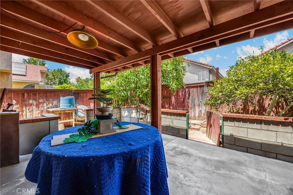 3631 Snowdrift Drive Riverside, CA 92503 - Photo 10 of 36 a view of a patio with table and chairs potted plants with floor to ceiling window and potted plants