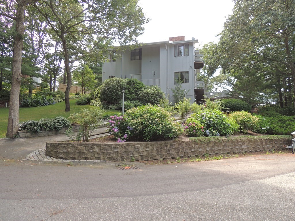 33 Studio Drive Bourne, MA 02532 - Photo 1 of 1 a front view of a house with a yard garage and outdoor seating