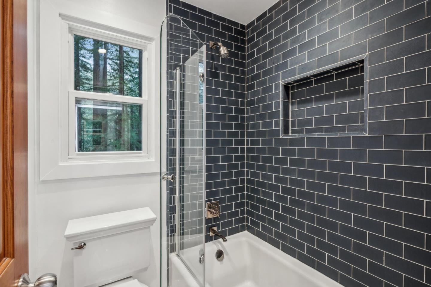 13872 Silver Sky Way Woodside, CA 94062 - Photo 52 of 78 a bathroom with a bathtub and next to a window