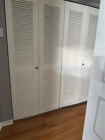 an empty room with wooden floor