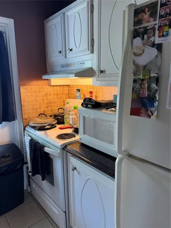 a kitchen with stainless steel appliances granite countertop a stove and a refrigerator