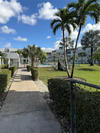 a view of a yard with swimming pool and green space
