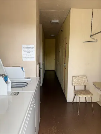 a kitchen with a table chairs and a refrigerator