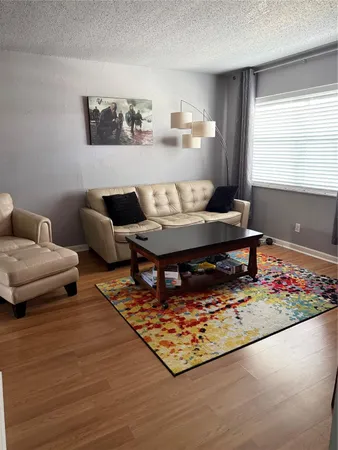 a living room with furniture and a rug
