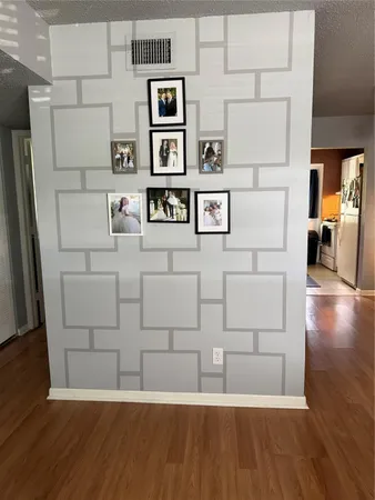 a view of kitchen with stainless steel appliances cabinets and wooden floor