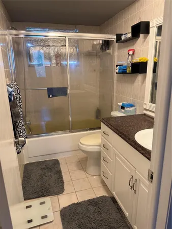 a bathroom with a sink a toilet a shower and a mirror