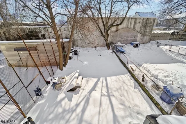 a view of a city with snow on the roadside