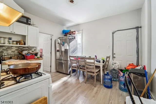 a work room with furniture a rug and gym equipment