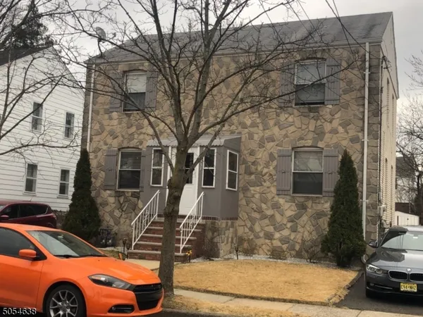 a front view of a house with parking space