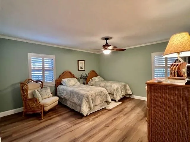 a bedroom with two beds and painting on the wall
