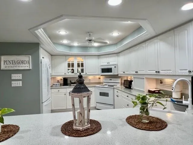 a kitchen with stainless steel appliances kitchen island granite countertop a sink a stove and cabinets