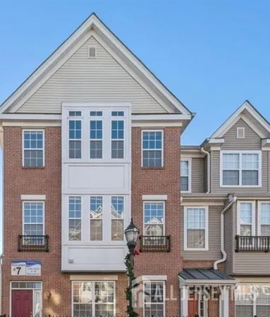 a view of a brick building next to a yard