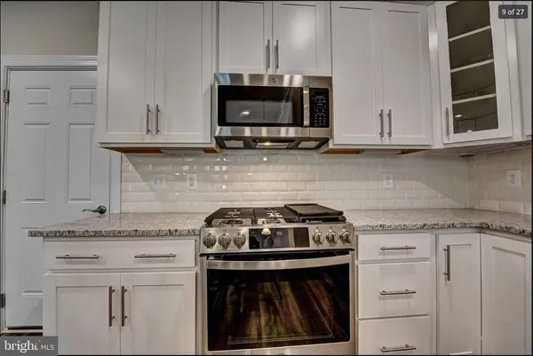 a stove top oven sitting inside of a kitchen