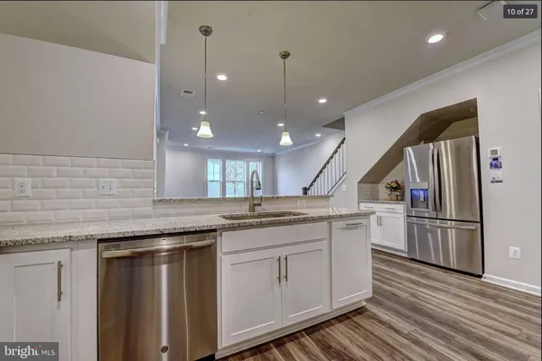 a kitchen with a sink and refrigerator
