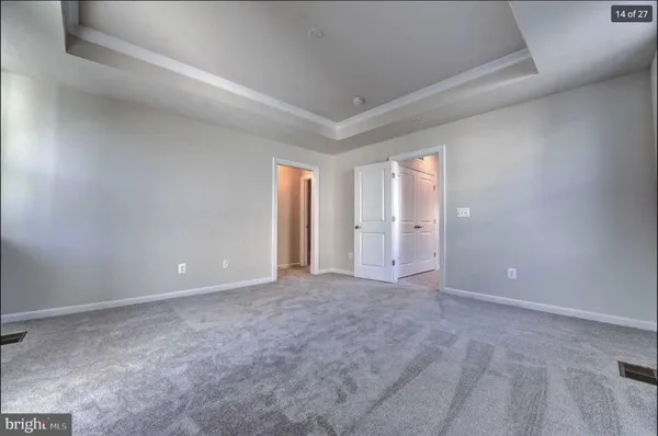 an empty room with windows and closet