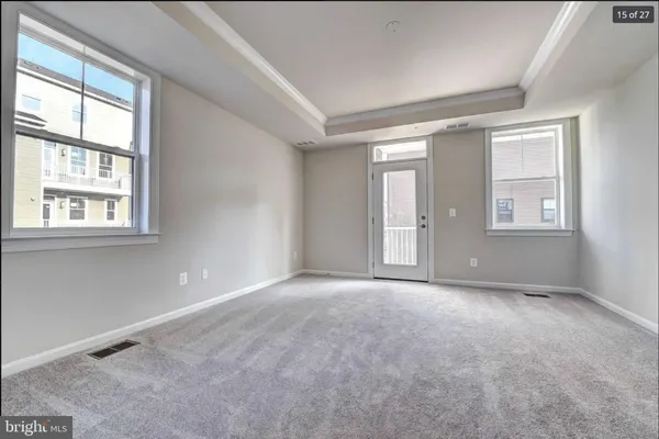an empty room with windows and closet