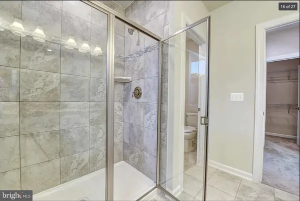 a bathroom with a shower and a sink