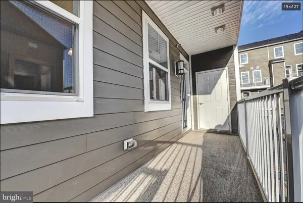 a view of a house with a wooden deck
