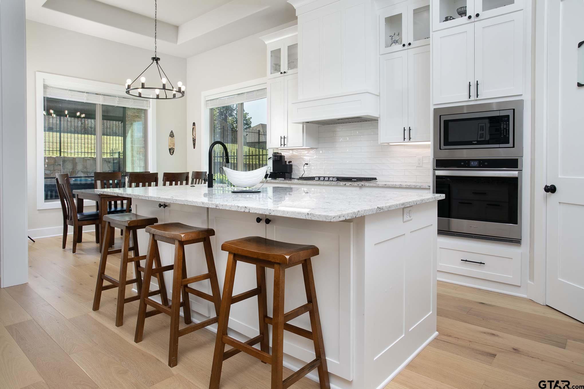 7434 Waterview Square Tyler, TX 75703 - Photo 1 of 32 a kitchen with stainless steel appliances kitchen island granite countertop a table and chairs in it