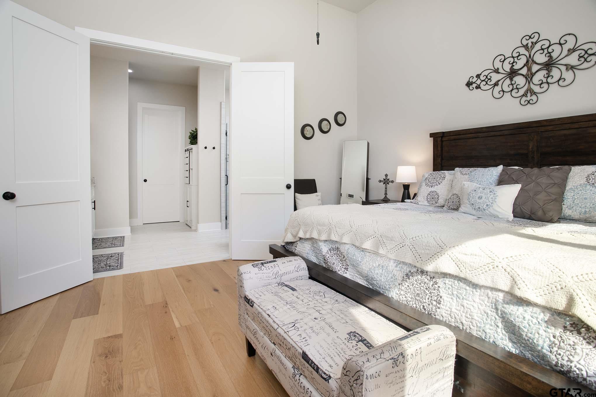 7434 Waterview Square Tyler, TX 75703 - Photo 14 of 33 a bedroom with a bed and a couch