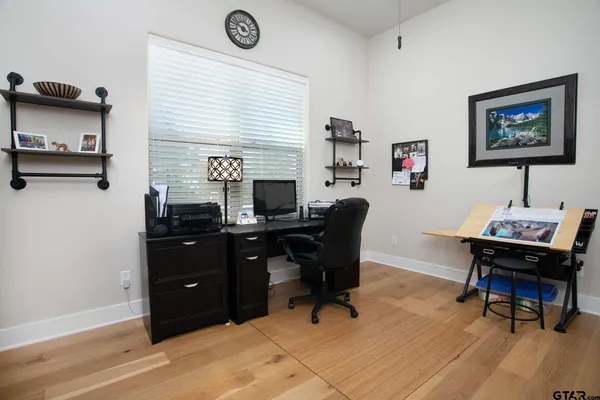 a view of a workspace with furniture and a window