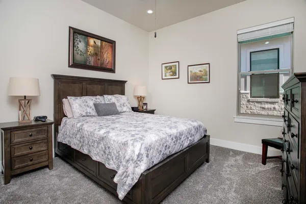 a spacious bedroom with a bed and a window
