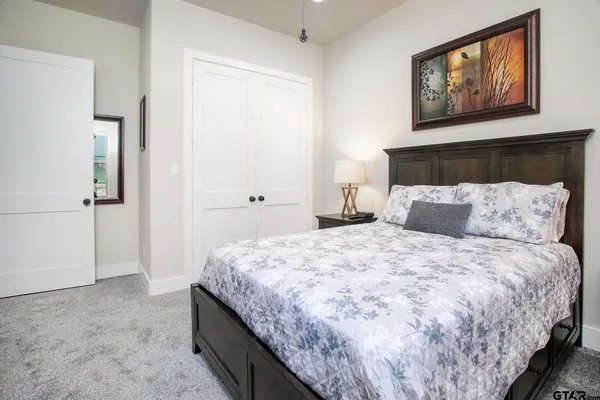 a bedroom with bed and window