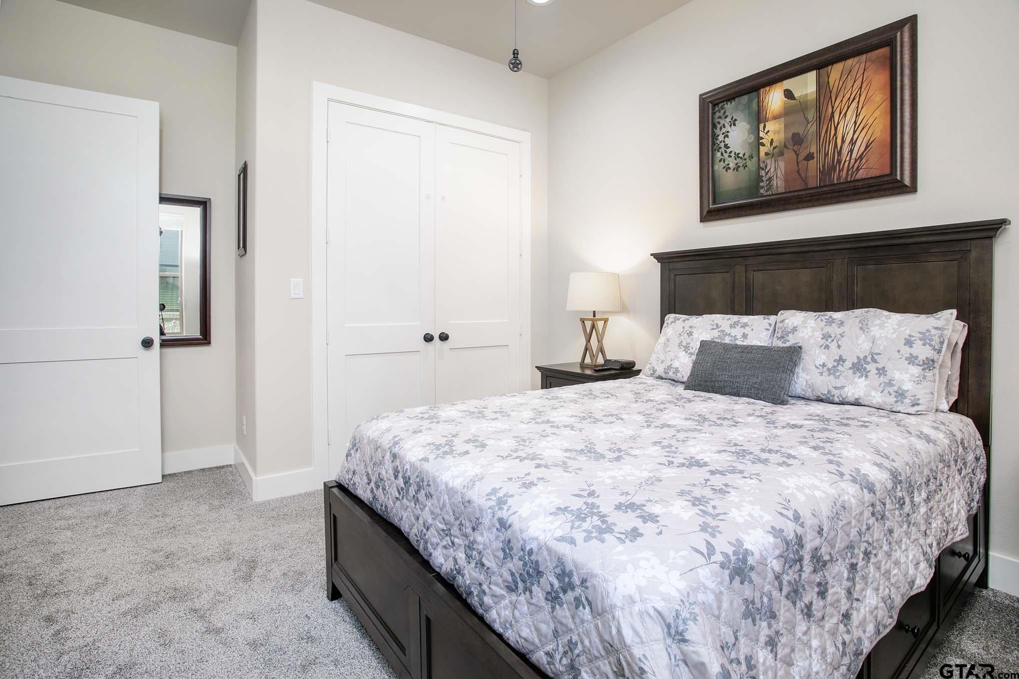 7434 Waterview Square Tyler, TX 75703 - Photo 24 of 33 a bedroom with bed and window