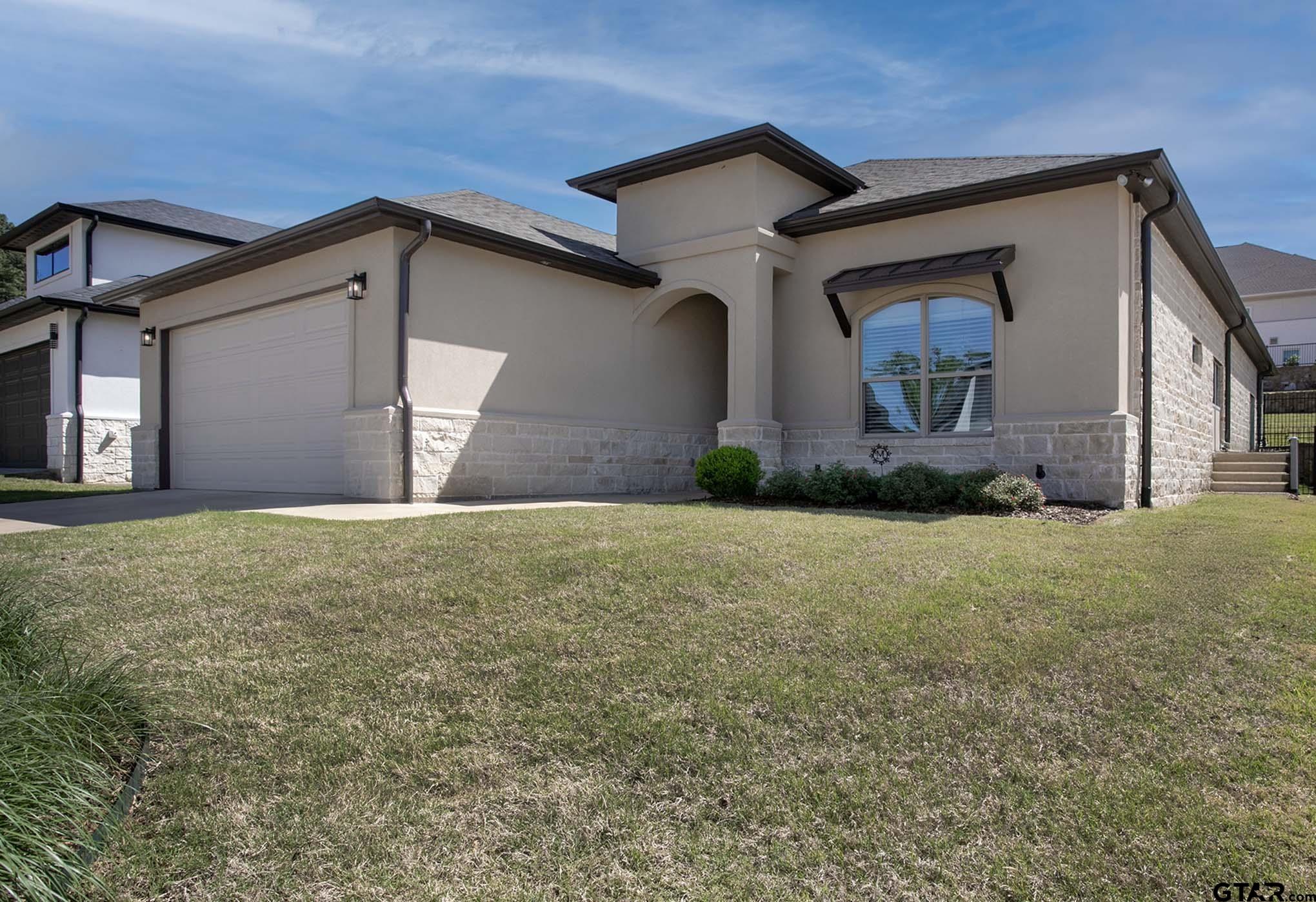 7434 Waterview Square Tyler, TX 75703 - Photo 5 of 32 a front view of a house with a yard