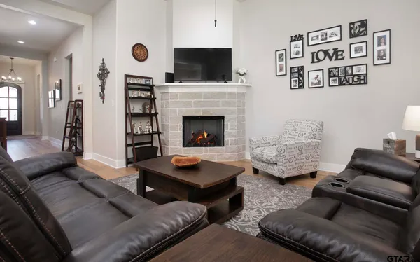 a living room with furniture and a fireplace