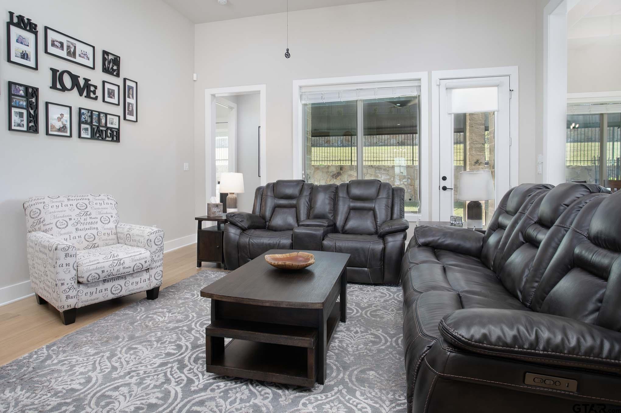 7434 Waterview Square Tyler, TX 75703 - Photo 9 of 32 a living room with furniture or couch and two windows